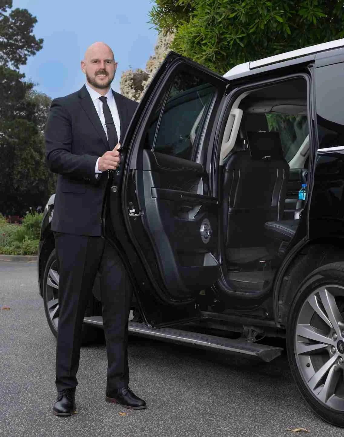Jon opening the door of his premium chauffeur vehicle